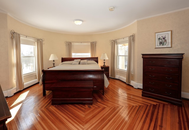 bedroom featuring baseboards and crown molding