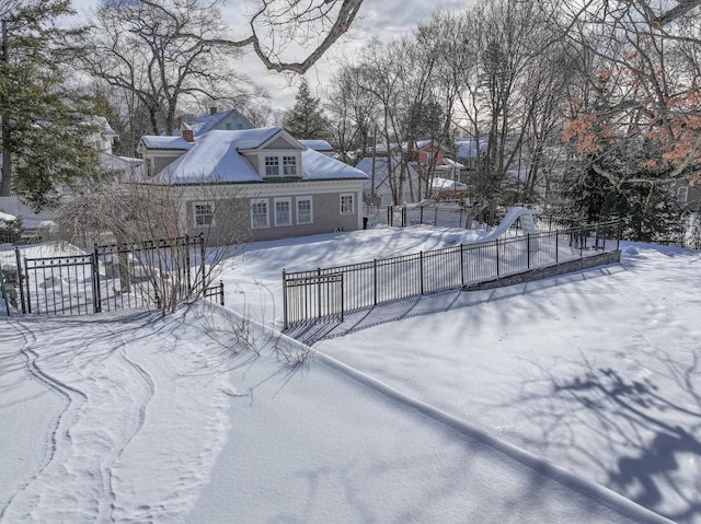 yard layered in snow featuring fence