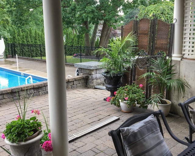 view of patio with fence and a fenced in pool