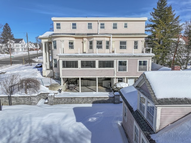 view of snow covered rear of property