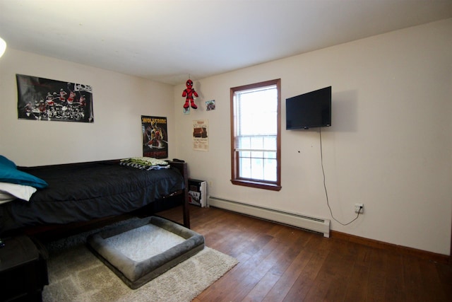 bedroom featuring a baseboard radiator, wood-type flooring, and baseboards