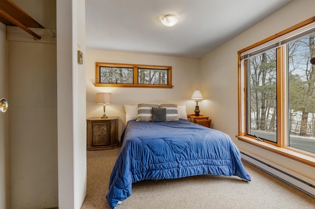 carpeted bedroom with a baseboard radiator