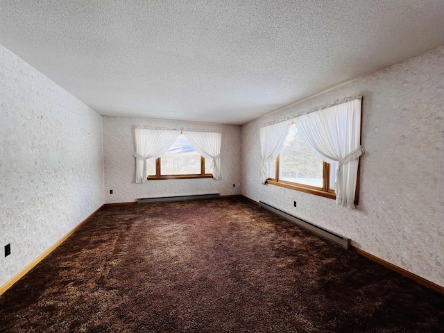 spare room with a baseboard radiator, dark carpet, a textured ceiling, and baseboards