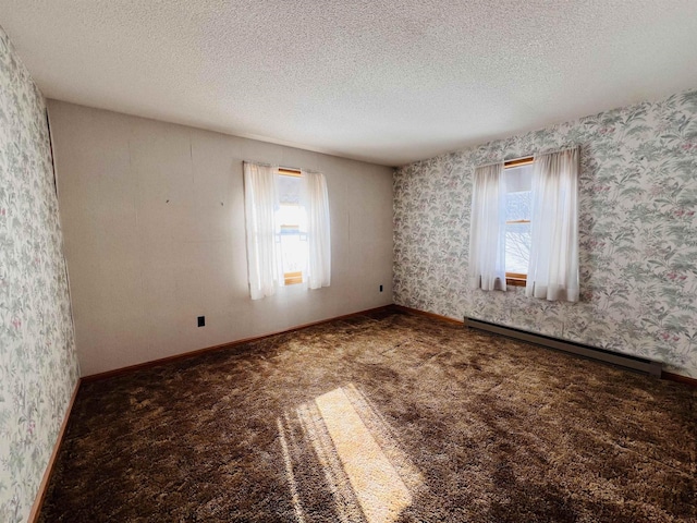 unfurnished room with a textured ceiling, carpet flooring, baseboards, baseboard heating, and wallpapered walls