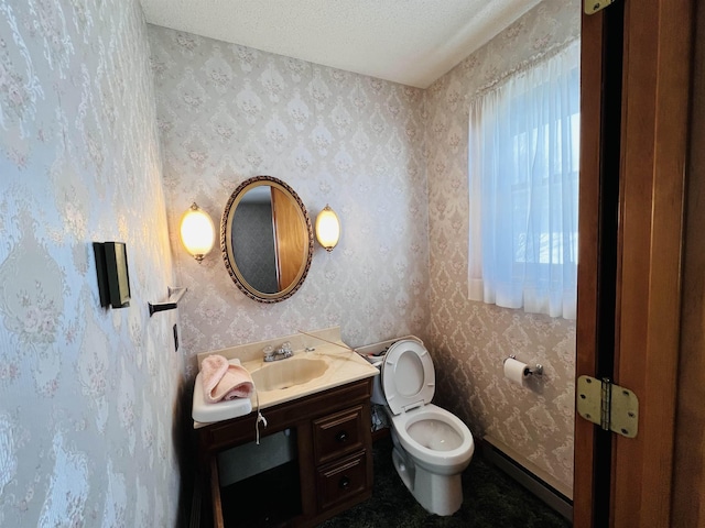 half bath with a textured ceiling, vanity, toilet, and wallpapered walls