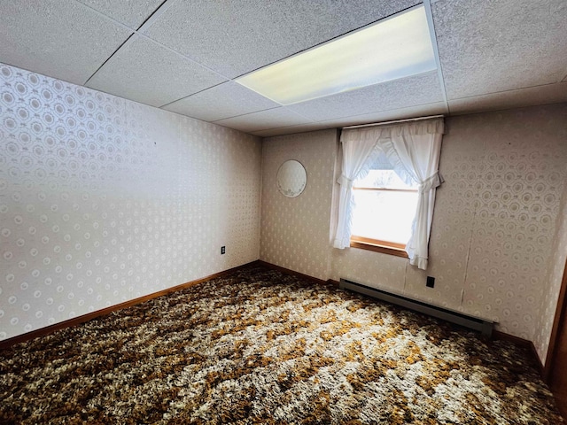 unfurnished room with carpet floors, wallpapered walls, and a baseboard radiator