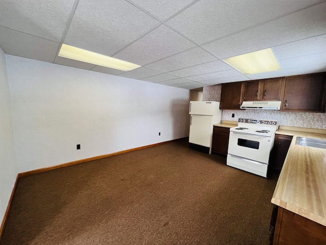 kitchen with dark brown cabinetry, white appliances, light countertops, dark colored carpet, and under cabinet range hood