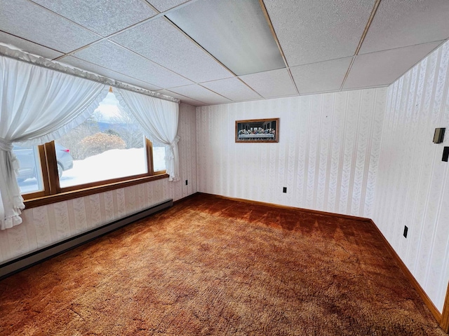 carpeted spare room featuring baseboards, a baseboard radiator, a paneled ceiling, and wallpapered walls