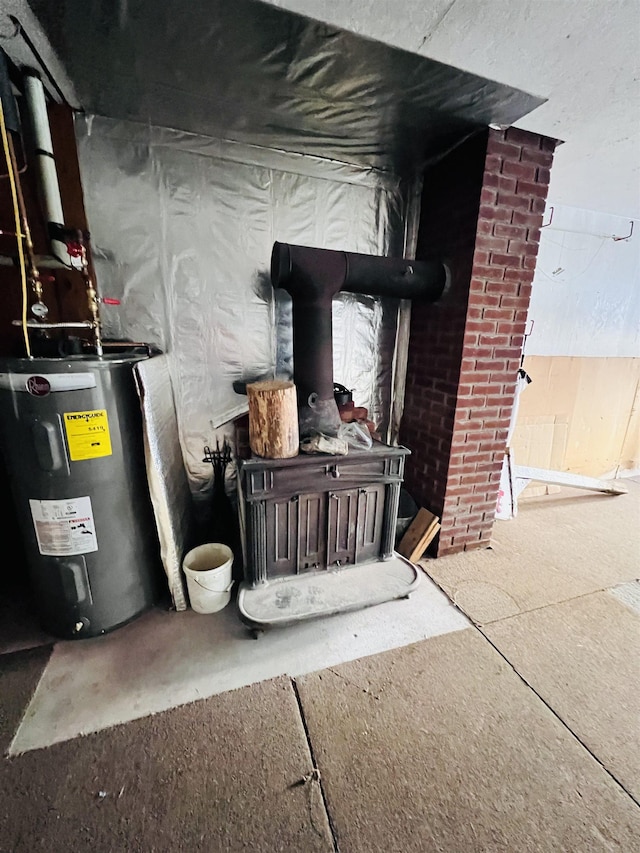 interior space with water heater and a wood stove