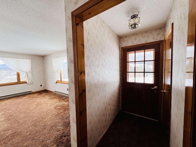 doorway to outside featuring a textured ceiling, a baseboard heating unit, dark carpet, and wallpapered walls