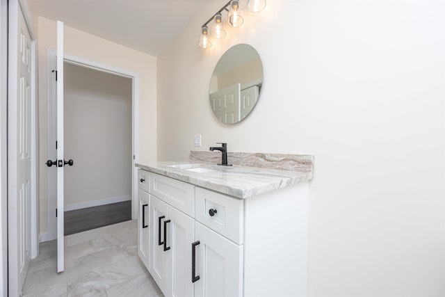 bathroom featuring baseboards and vanity