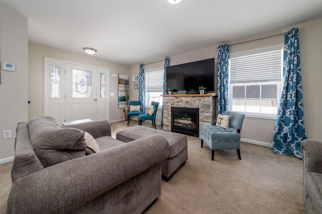 living room with light carpet, plenty of natural light, a fireplace, and baseboards