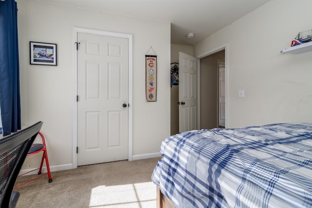 carpeted bedroom featuring baseboards