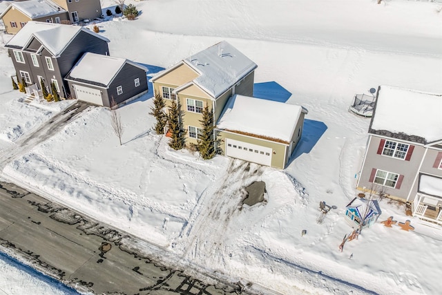 snowy aerial view with a residential view