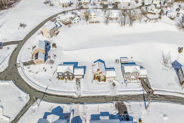 snowy aerial view featuring a residential view