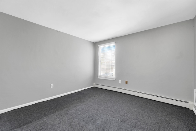 empty room with a baseboard radiator and baseboards