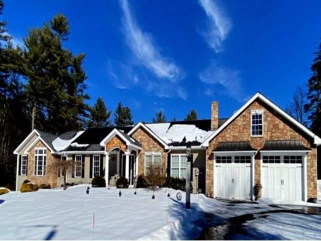 view of front of house with a chimney and an attached garage