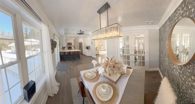 dining room featuring a textured ceiling, visible vents, french doors, dark wood finished floors, and crown molding