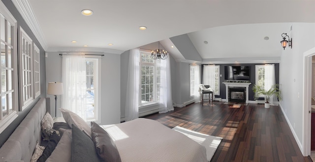 bedroom with baseboards, a glass covered fireplace, dark wood-style floors, crown molding, and recessed lighting