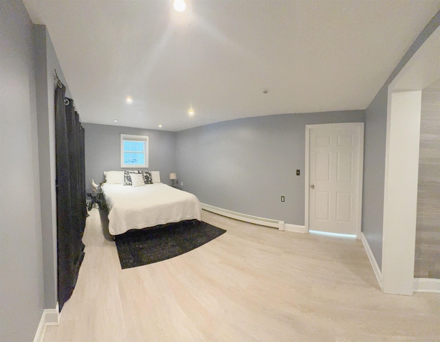 bedroom with a baseboard radiator, recessed lighting, baseboards, and wood finished floors