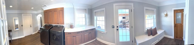 doorway to outside with washing machine and clothes dryer, dark wood finished floors, and crown molding