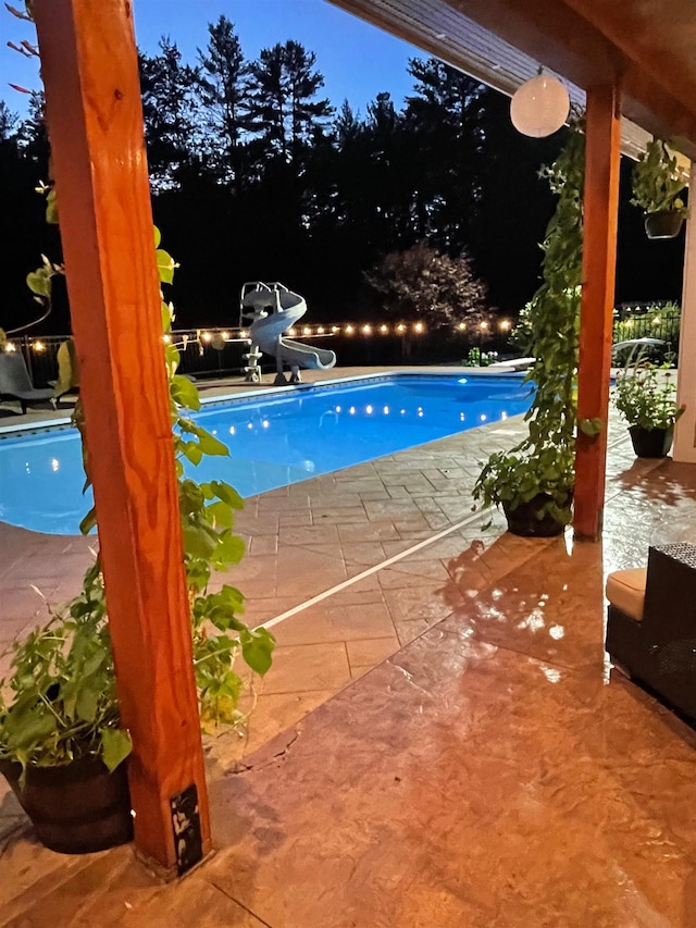 outdoor pool featuring a patio and a water slide