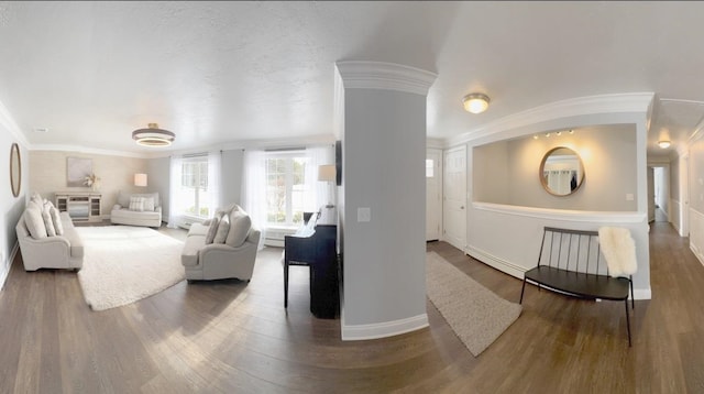 living room with baseboards, wood finished floors, and crown molding