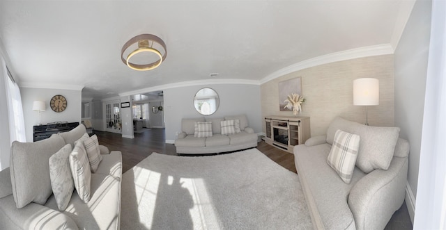 living room with baseboards, ornamental molding, and wood finished floors