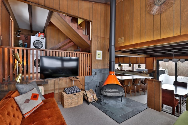 165 Upper Round Top Ext, Plymouth, VT 05056 - living room with beam ceiling, carpet flooring, a wood stove, and wooden walls