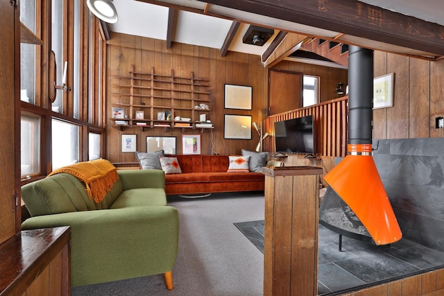165 Upper Round Top Ext, Plymouth, VT 05056 - carpeted living room with a wood stove, wooden walls, and beam ceiling