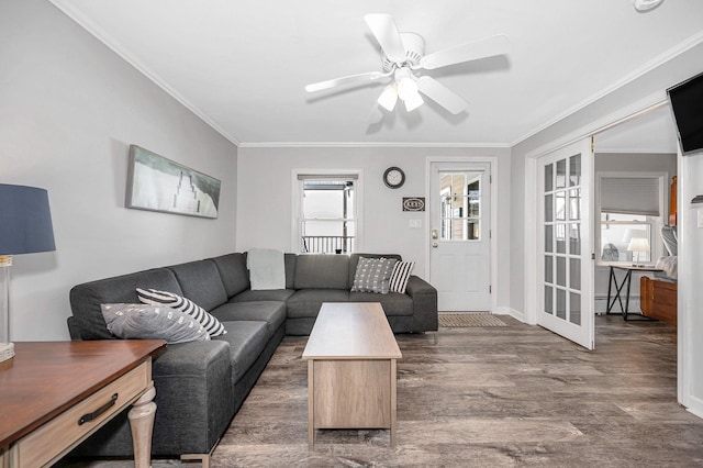 living room with ornamental molding, a baseboard radiator, ceiling fan, and wood finished floors