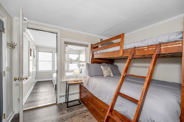 bedroom with baseboards, crown molding, a baseboard heating unit, and dark wood-style flooring