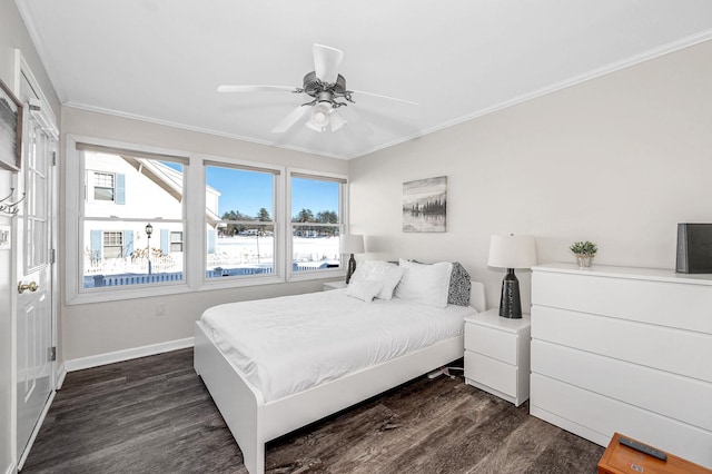 bedroom featuring ceiling fan, baseboards, dark wood-style flooring, and crown molding