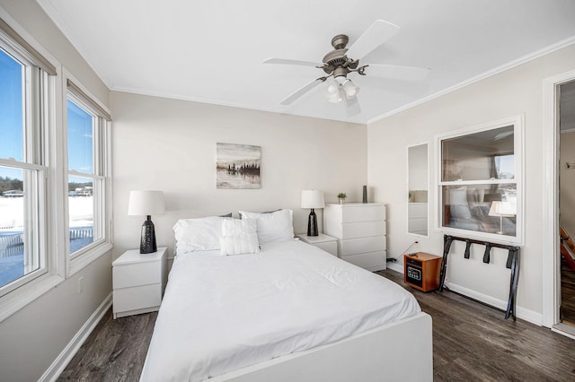 bedroom with baseboards, ceiling fan, wood finished floors, and crown molding