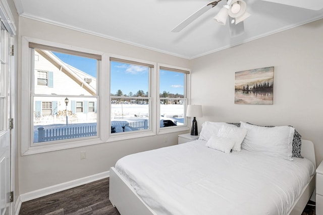 bedroom featuring ornamental molding, dark wood-style flooring, a ceiling fan, and baseboards