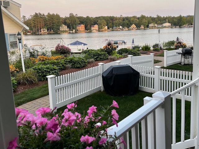 view of yard featuring a water view and fence