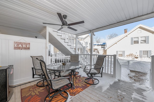 deck with a ceiling fan, outdoor dining area, and stairway