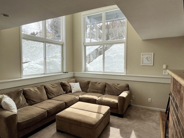 carpeted living room featuring a fireplace and baseboards