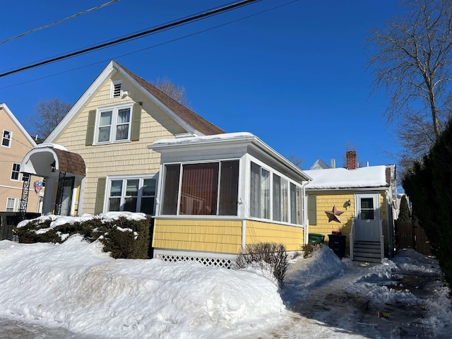 view of front of property featuring entry steps and a sunroom