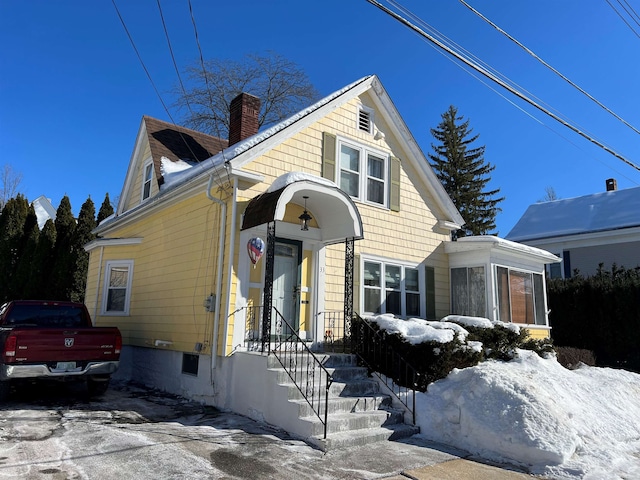 view of front of house featuring a chimney