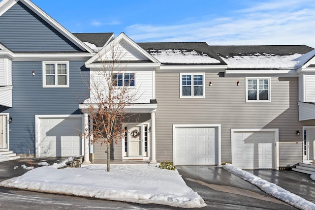 townhome / multi-family property featuring a garage and driveway