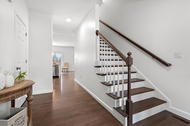 staircase with baseboards, visible vents, wood finished floors, and recessed lighting