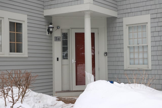 view of snow covered property entrance