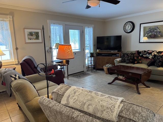 living area with light tile patterned floors, a ceiling fan, and crown molding