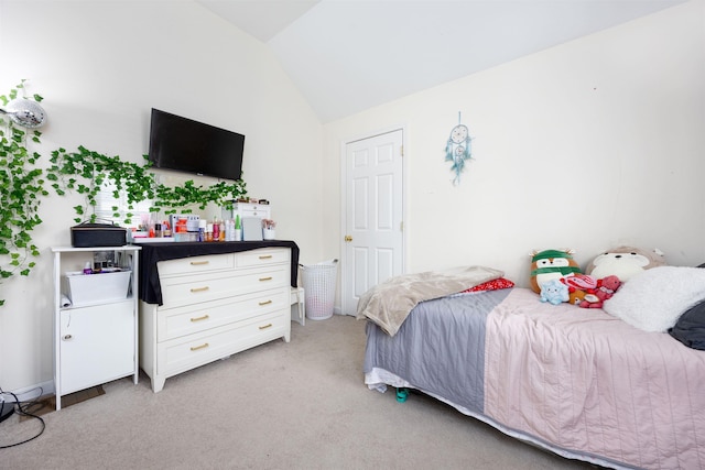 bedroom with light carpet and vaulted ceiling