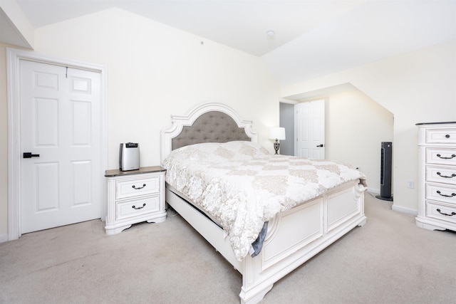 bedroom featuring lofted ceiling and light colored carpet