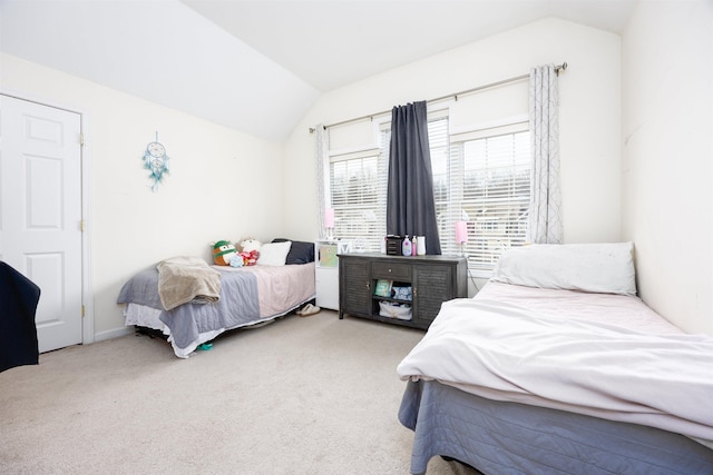 carpeted bedroom featuring lofted ceiling