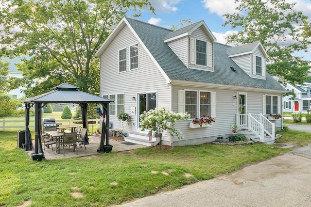 view of front of house with a shingled roof, a front yard, a patio, and a gazebo