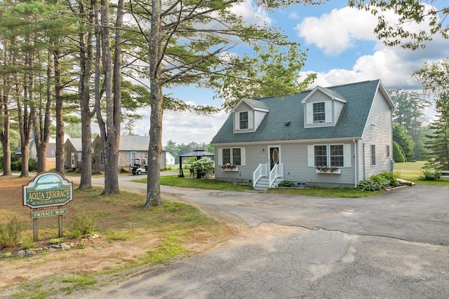 new england style home with a shingled roof