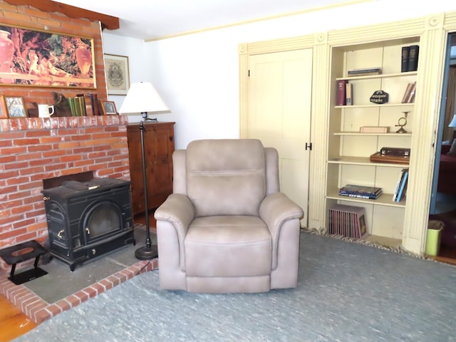 sitting room featuring a wood stove